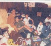 Melone Boys - Christmas - Steve in foreground with glasses, Back Row From Left to Right is Don, Ron, Mike, Chris and Joe Reading a Book